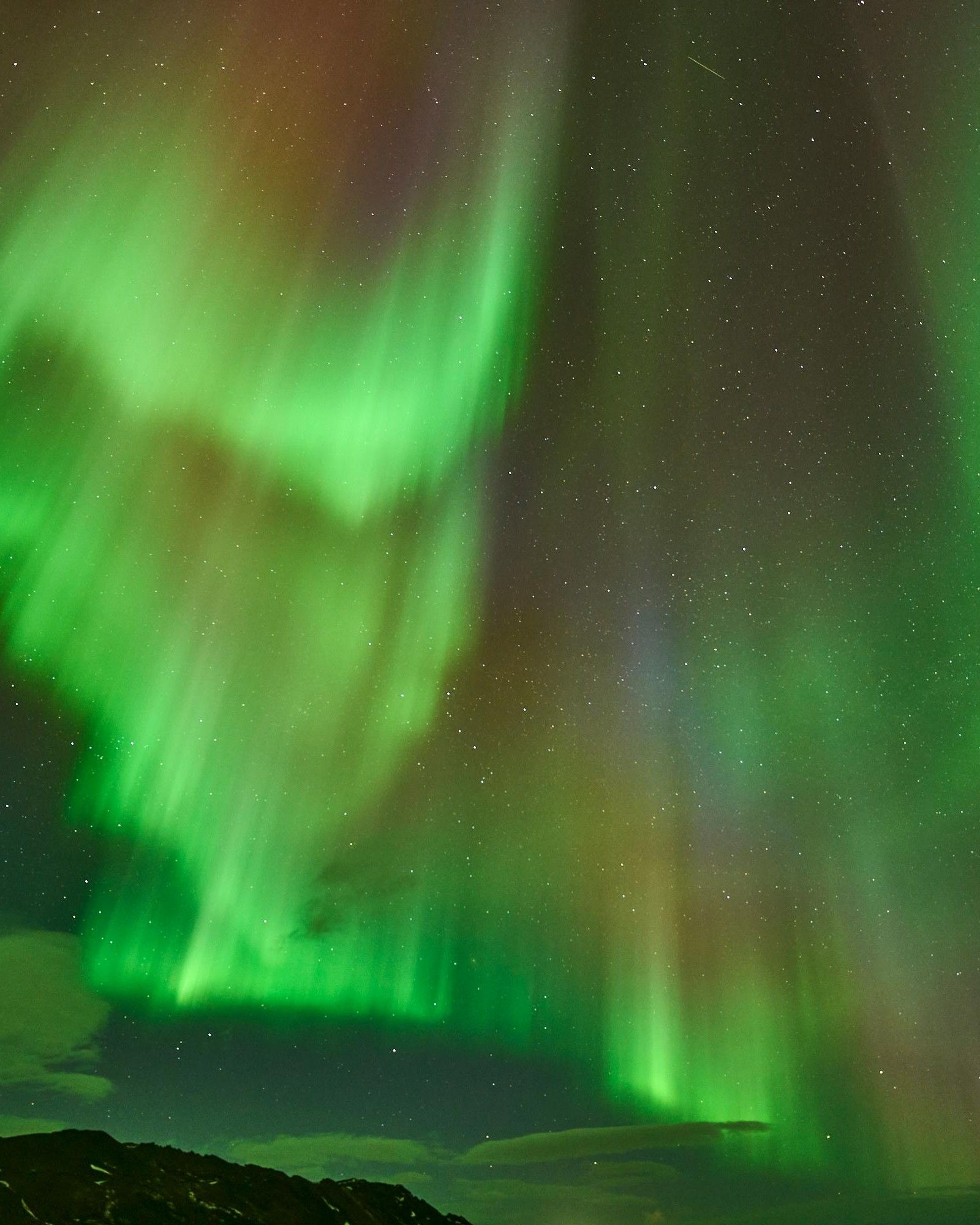 northern lights display of green and purple lights over Iceland